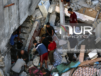 Palestinians inspect the damage to a building following Israeli bombardment in the Maghazi camp for Palestinian refugees in the central Gaza...