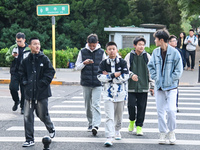 Citizens walk in thick clothes as temperatures plummet in Beijing, China, on October 19, 2024. (