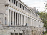 People explore the old town in Athens, Greece, on October 19, 2024. (