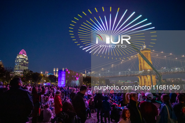 Spectators are seen during a light exhibit at the 2024 Blink Art and Light Festival in Cincinnati, Ohio, on October 18, 2024. 