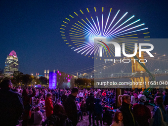 Spectators are seen during a light exhibit at the 2024 Blink Art and Light Festival in Cincinnati, Ohio, on October 18, 2024. (