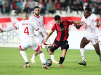 Tagnouo Mbe Jacques Amour of CR Belouizdad (R) fights for the ball with Ait el Hadj Mohamed (C) of USM Alger during the football match betwe...