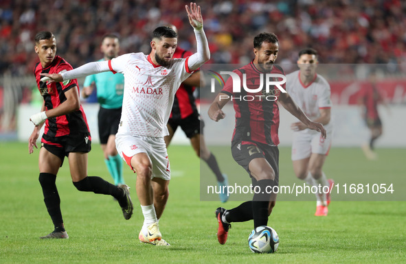 Chaabi Hedy of CR Belouizdad (left) fights for the ball with Allilet Adem (right) of USM Alger during the football match between CR Belouizd...