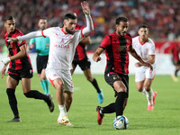 Chaabi Hedy of CR Belouizdad (left) fights for the ball with Allilet Adem (right) of USM Alger during the football match between CR Belouizd...