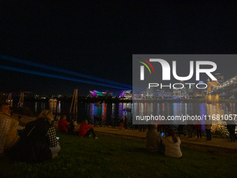 Spectators are seen during a light exhibit at the 2024 Blink Art and Light Festival in Cincinnati, Ohio, on October 18, 2024. (