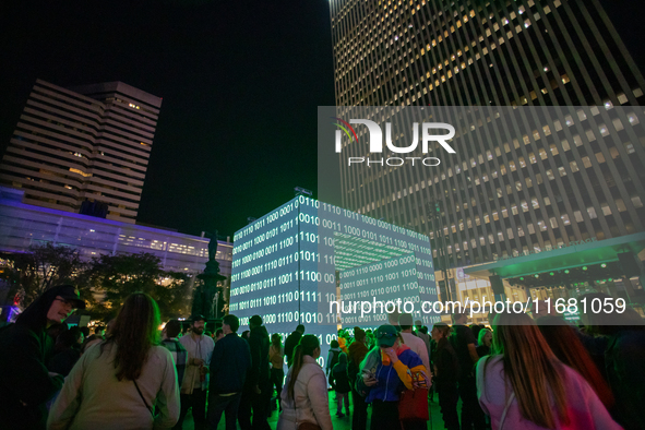 Spectators are seen during a light exhibit at the 2024 Blink Art and Light Festival in Cincinnati, Ohio, on October 18, 2024. 