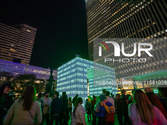 Spectators are seen during a light exhibit at the 2024 Blink Art and Light Festival in Cincinnati, Ohio, on October 18, 2024. (