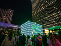 Spectators are seen during a light exhibit at the 2024 Blink Art and Light Festival in Cincinnati, Ohio, on October 18, 2024. (