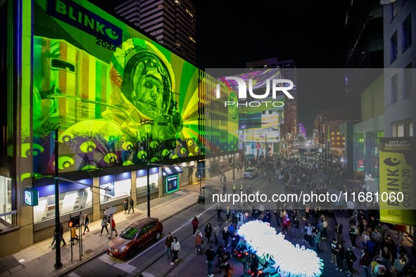 Spectators are seen during a light exhibit at the 2024 Blink Art and Light Festival in Cincinnati, Ohio, on October 18, 2024. 