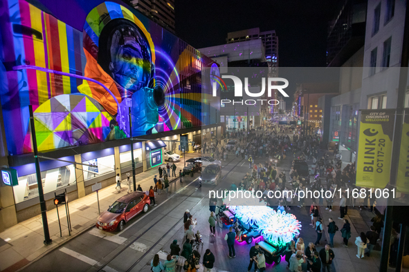 Spectators are seen during a light exhibit at the 2024 Blink Art and Light Festival in Cincinnati, Ohio, on October 18, 2024. 