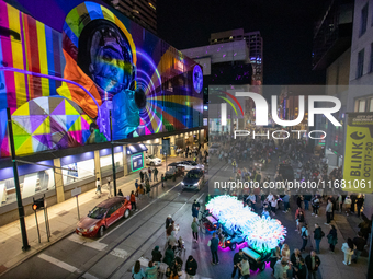 Spectators are seen during a light exhibit at the 2024 Blink Art and Light Festival in Cincinnati, Ohio, on October 18, 2024. (