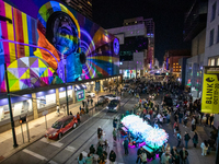 Spectators are seen during a light exhibit at the 2024 Blink Art and Light Festival in Cincinnati, Ohio, on October 18, 2024. (