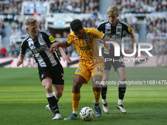 Lewis Hall and Anthony Gordon of Newcastle United close down Georginio Rutter of Brighton and Hove Albion during the Premier League match be...