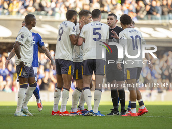 Referee Michael Oliver is surrounded by Everton players during the Premier League match between Ipswich Town and Everton at Portman Road in...