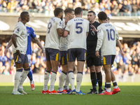 Referee Michael Oliver is surrounded by Everton players during the Premier League match between Ipswich Town and Everton at Portman Road in...