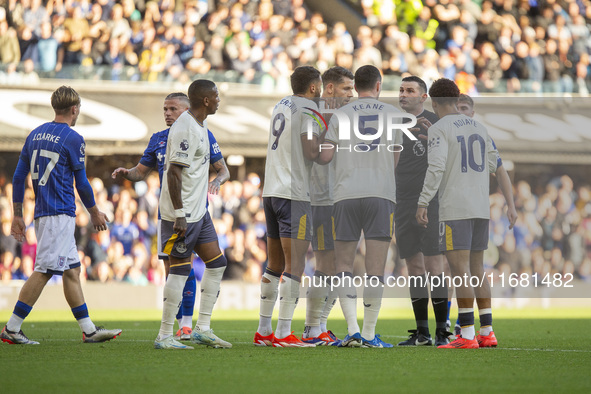 Referee Michael Oliver is surrounded by Everton players during the Premier League match between Ipswich Town and Everton at Portman Road in...