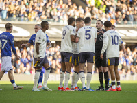 Referee Michael Oliver is surrounded by Everton players during the Premier League match between Ipswich Town and Everton at Portman Road in...