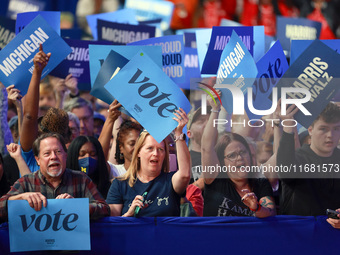 Waterford, MICHIGAN - OCTOBER 18: Attendees at the rally for US Vice President and Democratic presidential candidate Kamala Harris hold sign...