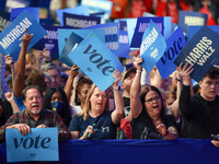 Waterford, MICHIGAN - OCTOBER 18: Attendees at the rally for US Vice President and Democratic presidential candidate Kamala Harris hold sign...