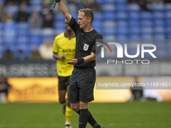 Referee Martin Coy shows a yellow card to Ryan Sweeney #6 of Burton Albion F.C. during the Sky Bet League 1 match between Bolton Wanderers a...