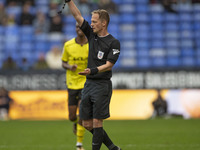 Referee Martin Coy shows a yellow card to Ryan Sweeney #6 of Burton Albion F.C. during the Sky Bet League 1 match between Bolton Wanderers a...