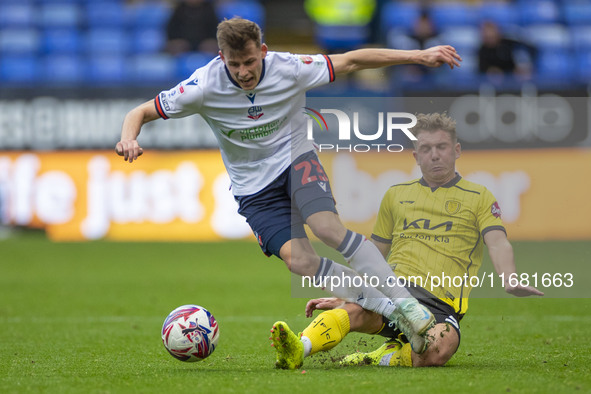 Szabolcs Schon #23 of Bolton Wanderers F.C. is tackled by Ben Whitfield #34 of Burton Albion F.C. during the Sky Bet League 1 match between...