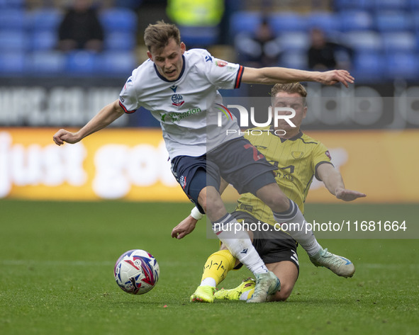 Szabolcs Schon #23 of Bolton Wanderers F.C. is tackled by Ben Whitfield #34 of Burton Albion F.C. during the Sky Bet League 1 match between...