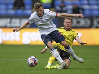 Szabolcs Schon #23 of Bolton Wanderers F.C. is tackled by Ben Whitfield #34 of Burton Albion F.C. during the Sky Bet League 1 match between...