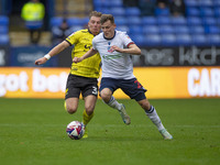 Szabolcs Schon #23 of Bolton Wanderers F.C. is tackled by Ben Whitfield #34 of Burton Albion F.C. during the Sky Bet League 1 match between...