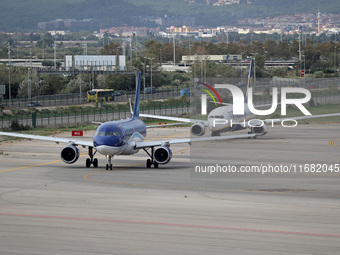 An Airbus A319-111 from Azerbaijan Airlines and a Boeing 737-8AS from Ryanair prepare for takeoff on the runway at Barcelona Airport in Barc...