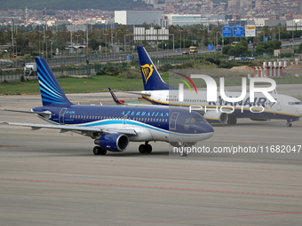 An Airbus A319-111 from Azerbaijan Airlines and a Boeing 737-8AS from Ryanair prepare for takeoff on the runway at Barcelona Airport in Barc...