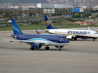 An Airbus A319-111 from Azerbaijan Airlines and a Boeing 737-8AS from Ryanair prepare for takeoff on the runway at Barcelona Airport in Barc...