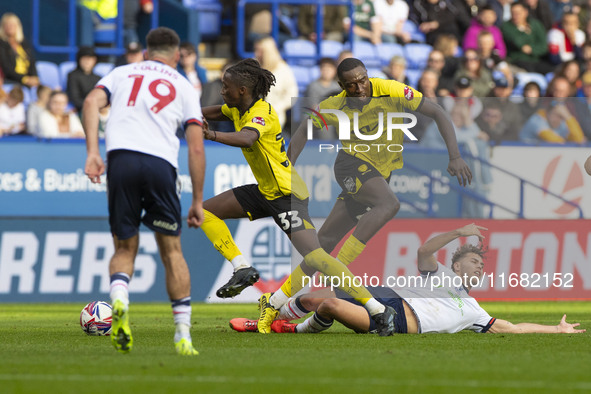 Dion Charles #10 of Bolton Wanderers F.C. is fouled by Kgagelo Chauke #33 of Burton Albion F.C. during the Sky Bet League 1 match between Bo...