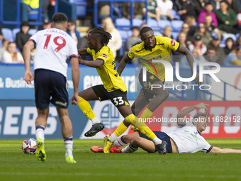 Dion Charles #10 of Bolton Wanderers F.C. is fouled by Kgagelo Chauke #33 of Burton Albion F.C. during the Sky Bet League 1 match between Bo...