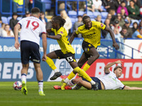 Dion Charles #10 of Bolton Wanderers F.C. is fouled by Kgagelo Chauke #33 of Burton Albion F.C. during the Sky Bet League 1 match between Bo...