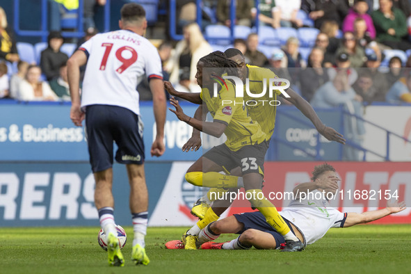 Dion Charles #10 of Bolton Wanderers F.C. is fouled by Kgagelo Chauke #33 of Burton Albion F.C. during the Sky Bet League 1 match between Bo...