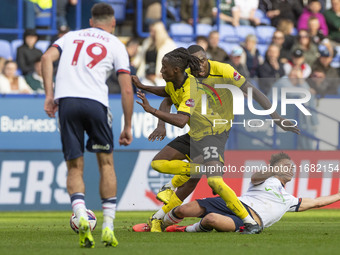 Dion Charles #10 of Bolton Wanderers F.C. is fouled by Kgagelo Chauke #33 of Burton Albion F.C. during the Sky Bet League 1 match between Bo...