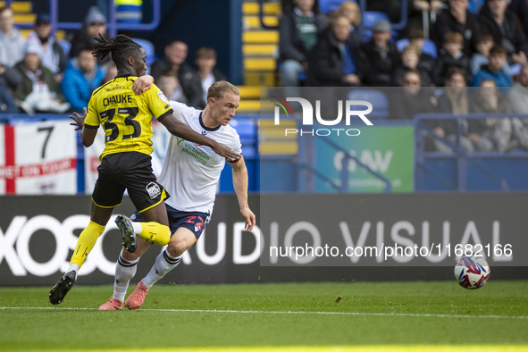 Kyle Dempsey #22 of Bolton Wanderers F.C. is tackled by Kgagelo Chauke #33 of Burton Albion F.C. during the Sky Bet League 1 match between B...