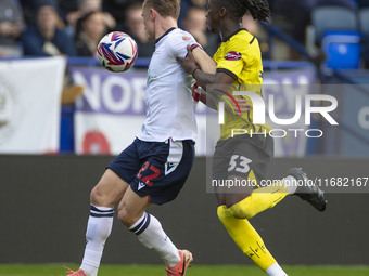 Kyle Dempsey #22 of Bolton Wanderers F.C. is tackled by Kgagelo Chauke #33 of Burton Albion F.C. during the Sky Bet League 1 match between B...