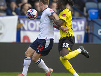 Kyle Dempsey #22 of Bolton Wanderers F.C. is tackled by Kgagelo Chauke #33 of Burton Albion F.C. during the Sky Bet League 1 match between B...