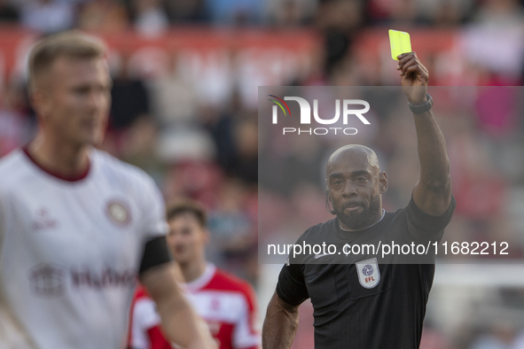 Referee Sam Allison shows the yellow card to Bristol City's Ross McCrorie during the Sky Bet Championship match between Middlesbrough and Br...