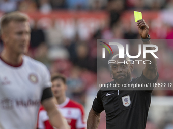 Referee Sam Allison shows the yellow card to Bristol City's Ross McCrorie during the Sky Bet Championship match between Middlesbrough and Br...