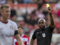 Referee Sam Allison shows the yellow card to Bristol City's Ross McCrorie during the Sky Bet Championship match between Middlesbrough and Br...