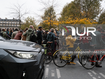 An SUV passes by the protesters during a gathering at the Place de La Republique in Paris, France, on October 19, 2024, to pay tribute to Pa...