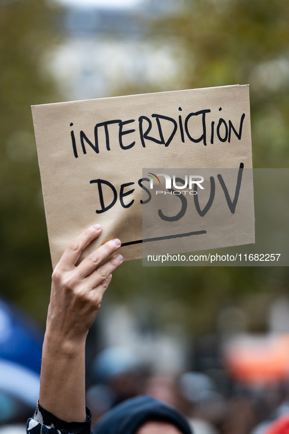 A demonstrator holds a sign reading ''SUV ban'' during a gathering at the Place de La Republique in Paris, France, on October 19, 2024, to p...