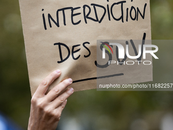 A demonstrator holds a sign reading ''SUV ban'' during a gathering at the Place de La Republique in Paris, France, on October 19, 2024, to p...