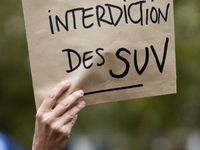 A demonstrator holds a sign reading ''SUV ban'' during a gathering at the Place de La Republique in Paris, France, on October 19, 2024, to p...