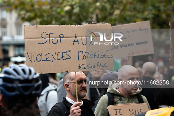 A man holds a sign reading ''Stop motorised violence'' during a gathering at the Place de La Republique in Paris, France, on October 19, 202...