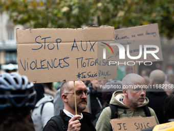 A man holds a sign reading ''Stop motorised violence'' during a gathering at the Place de La Republique in Paris, France, on October 19, 202...