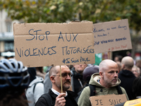 A man holds a sign reading ''Stop motorised violence'' during a gathering at the Place de La Republique in Paris, France, on October 19, 202...